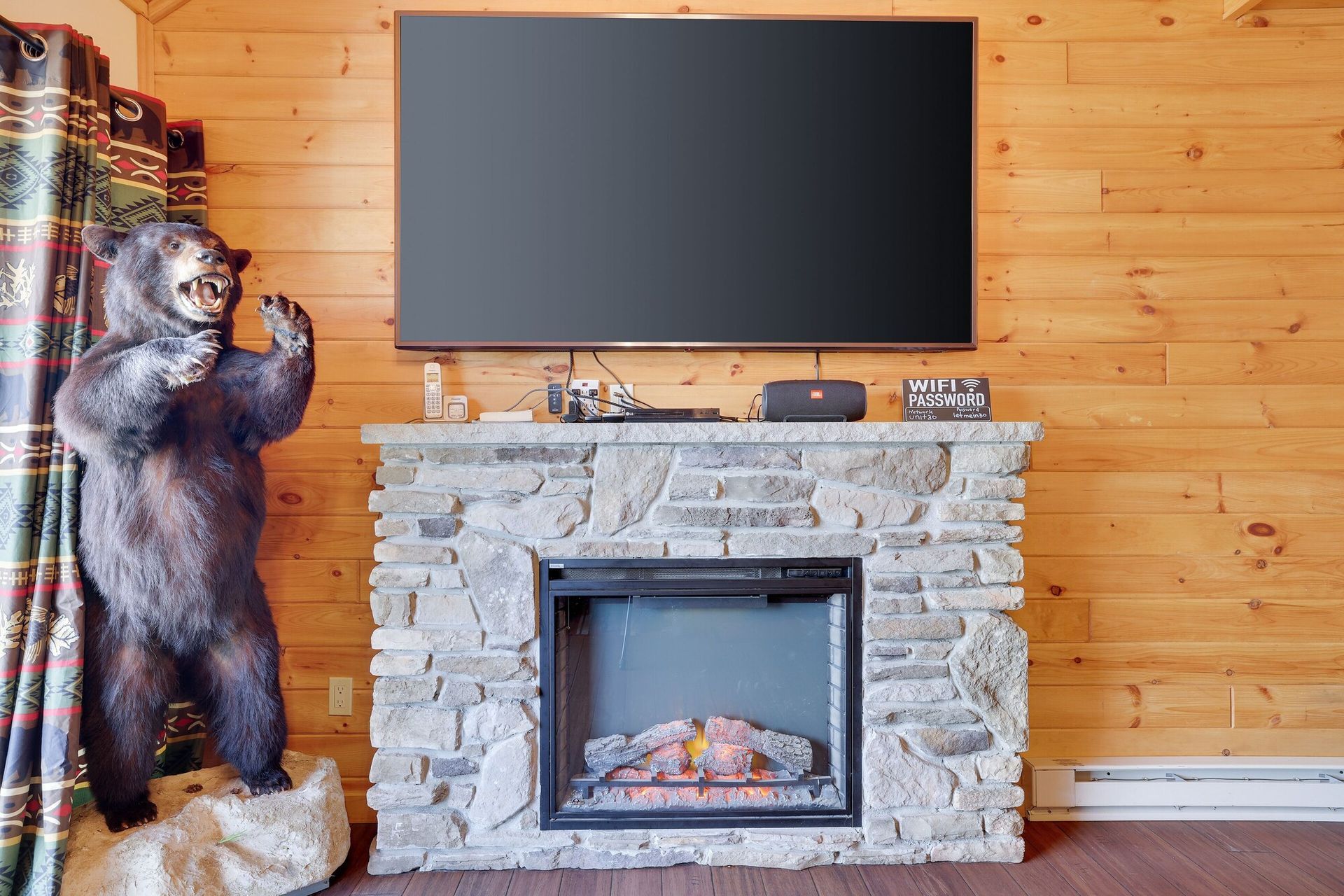 A living room with a fireplace and a flat screen tv.