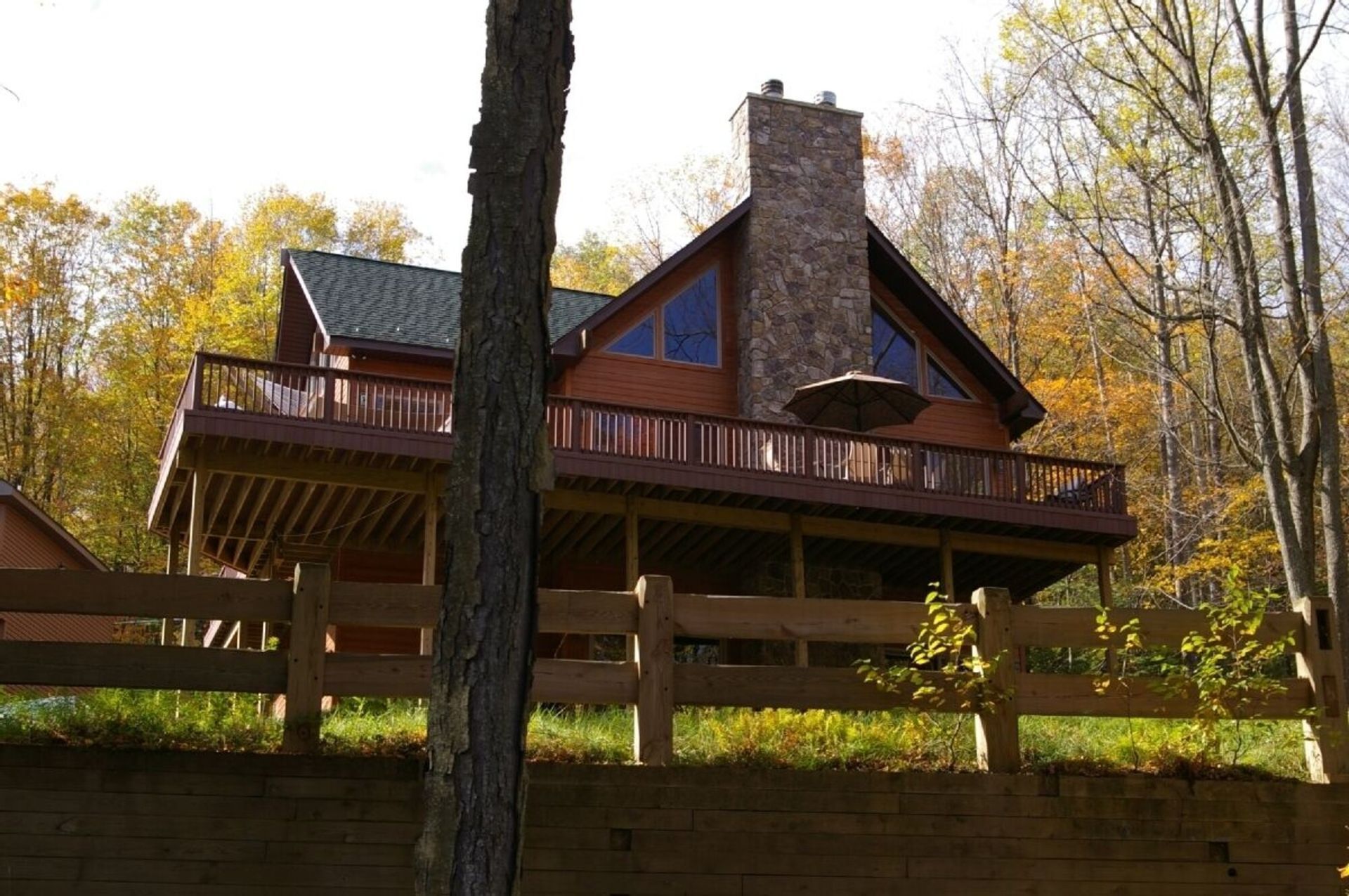 A large house with a wooden fence in front of it