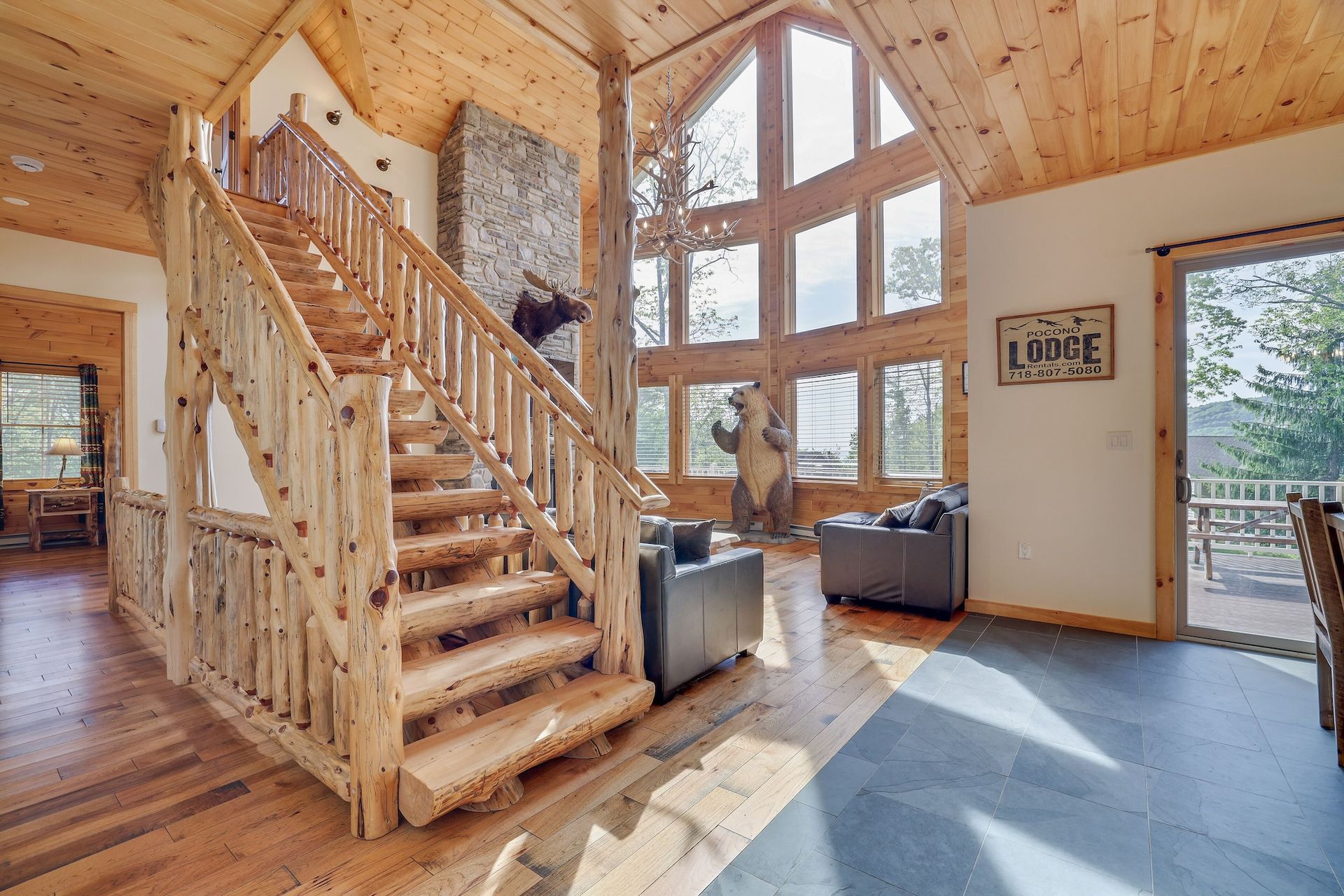 A wooden staircase leading up to the second floor of a log cabin.