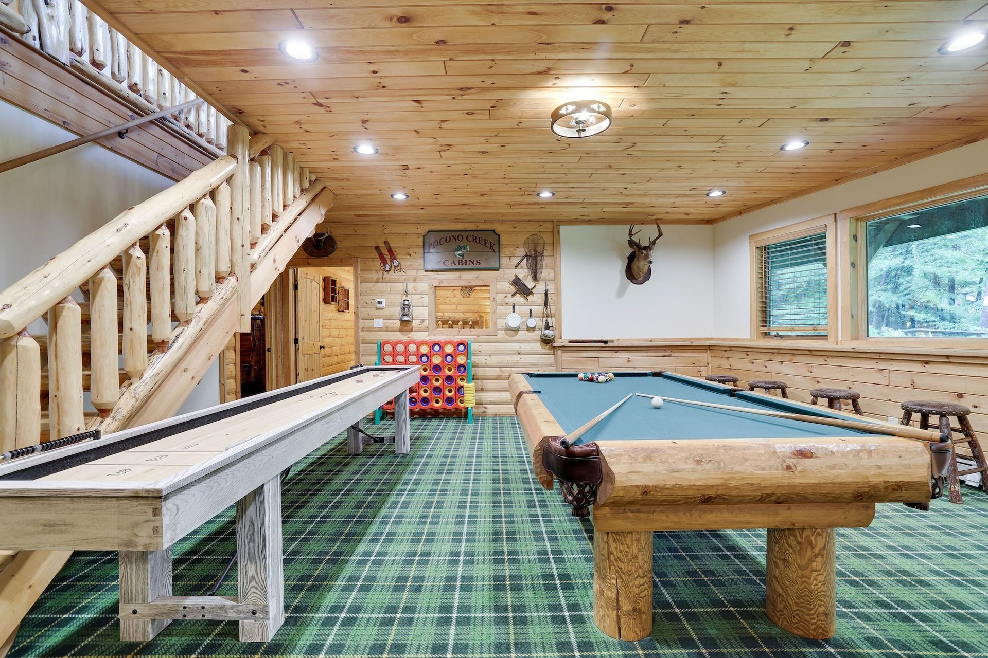 There is a pool table in the middle of the room.