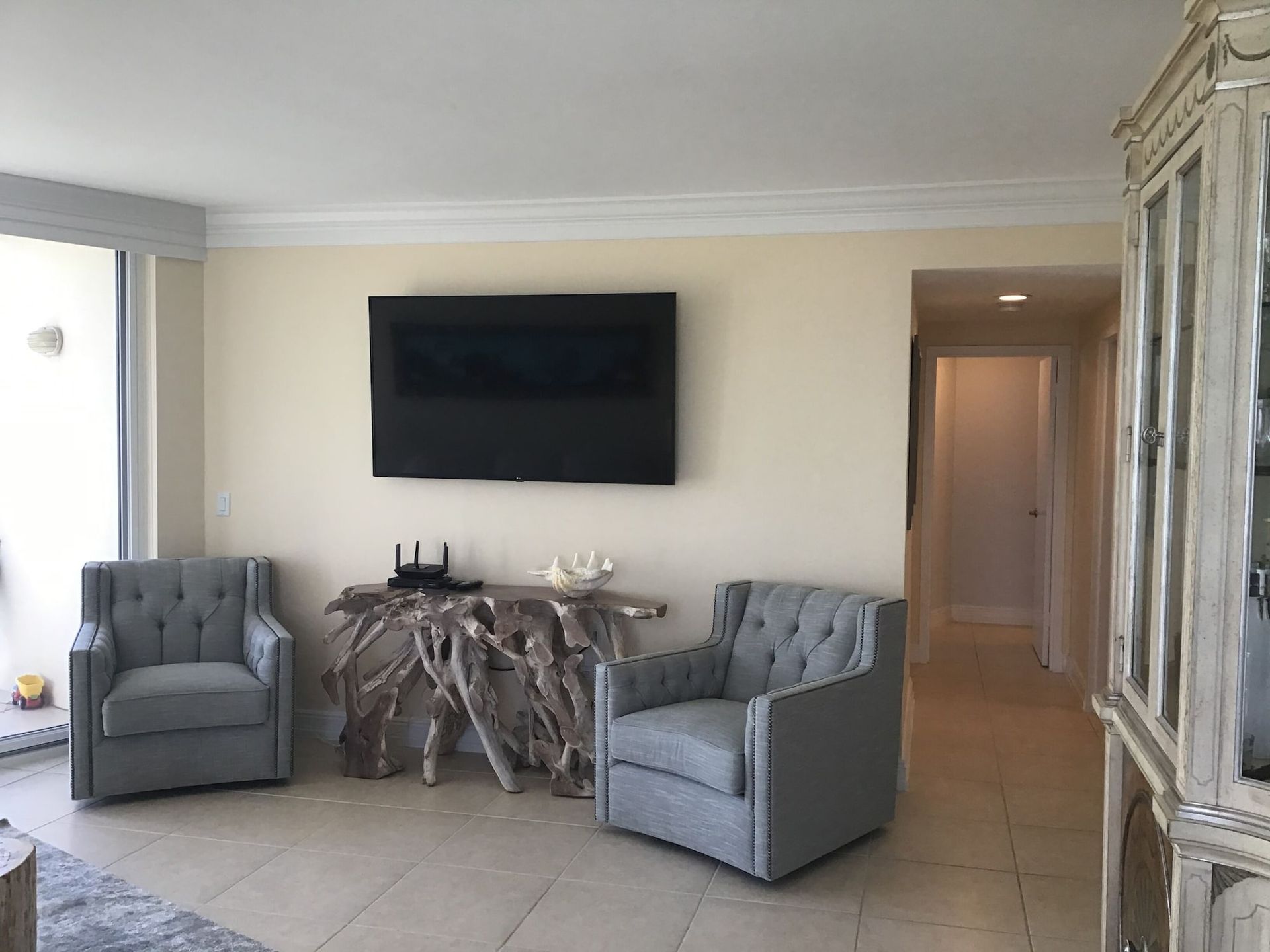 A living room with two chairs and a flat screen tv