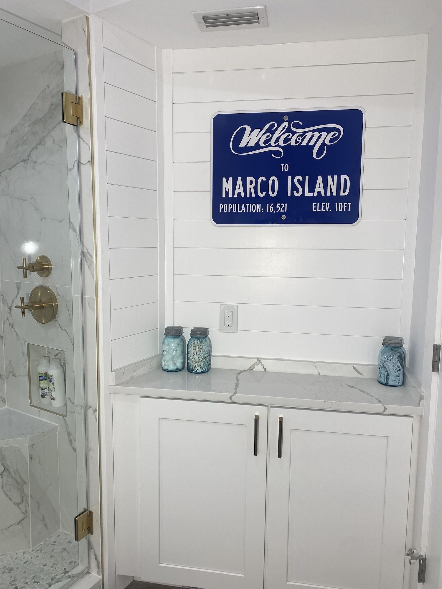 A bathroom with a sign that says welcome to marco island