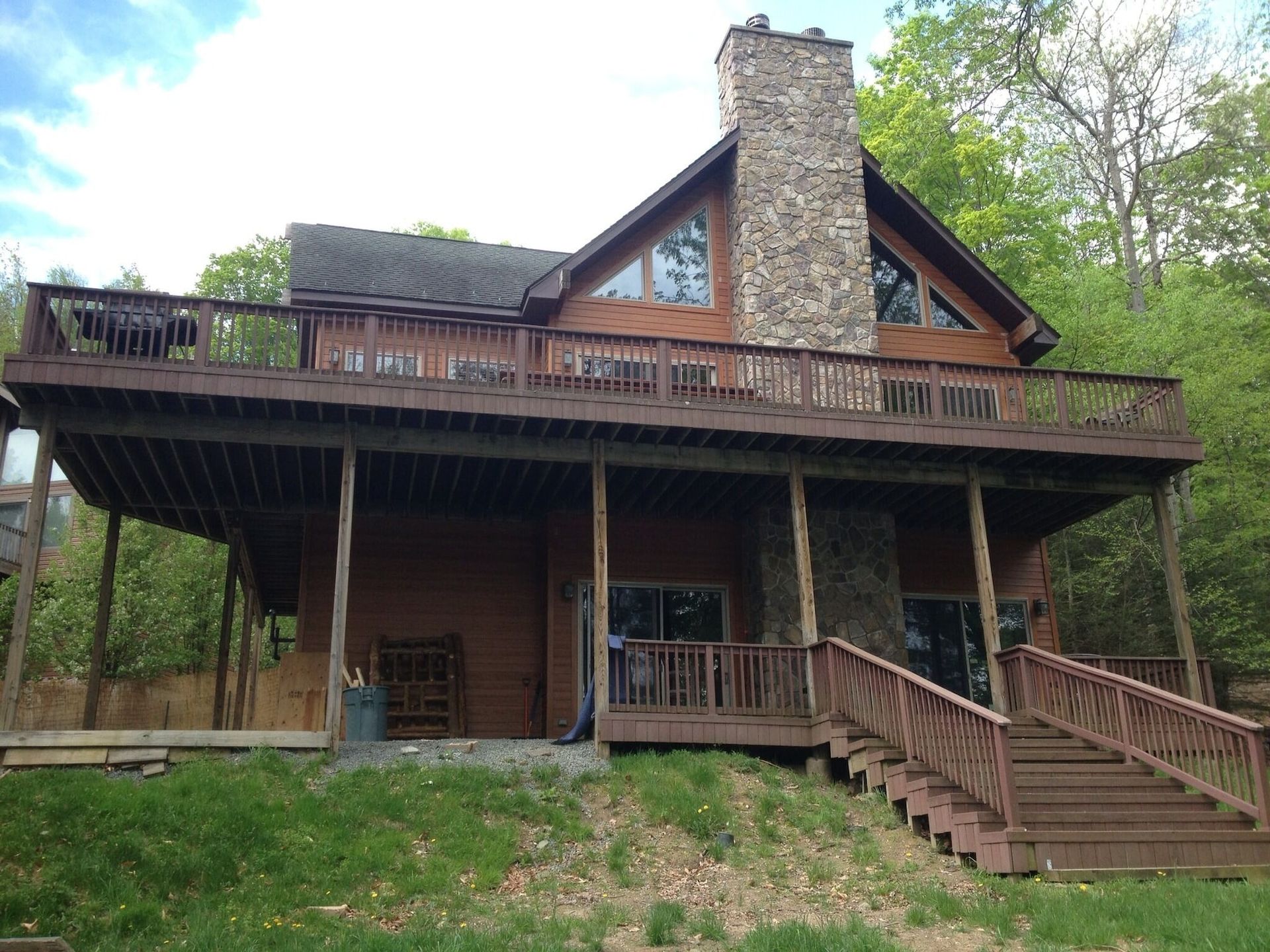 A large house with a large deck and stairs