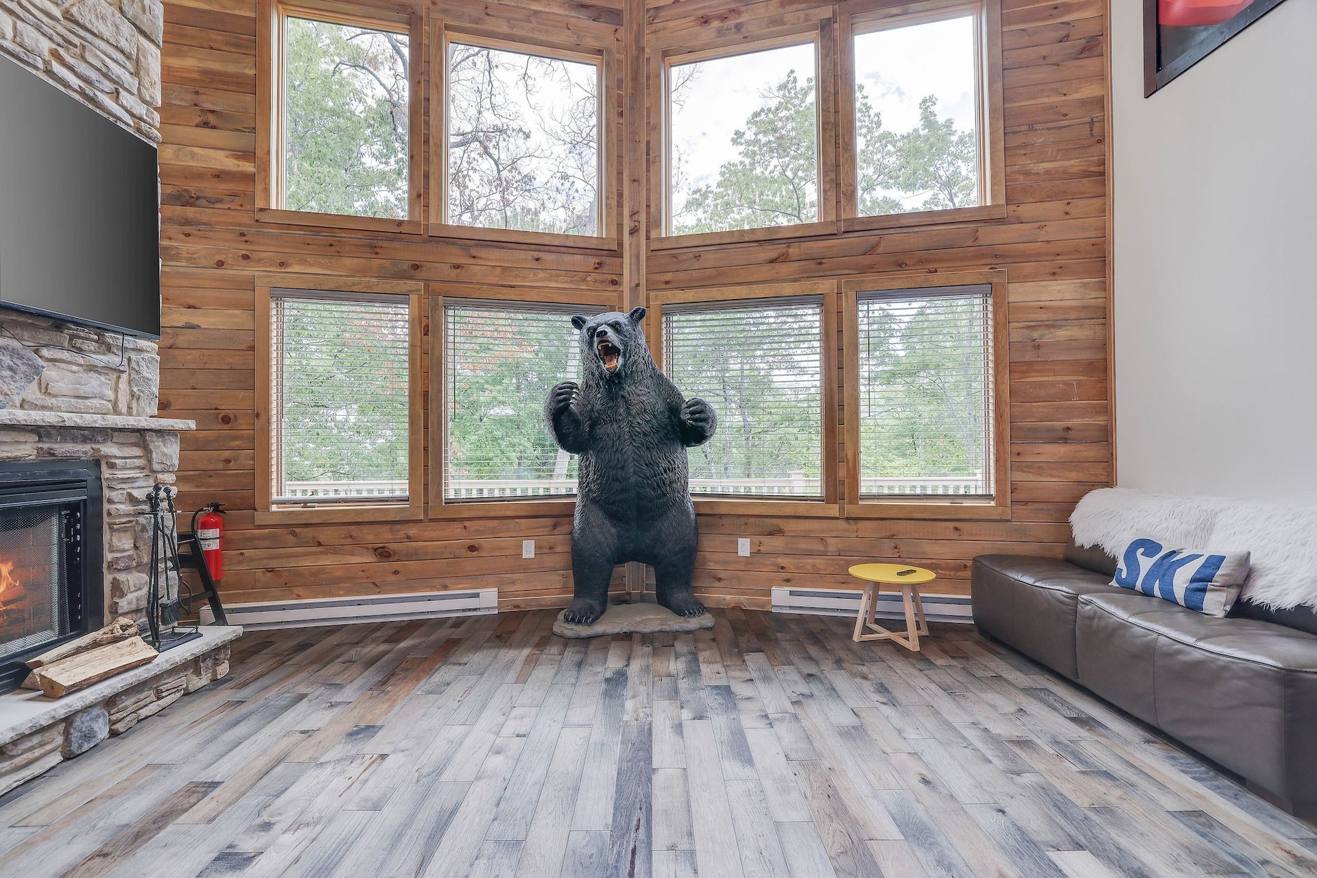 A living room with a statue of a bear and a fireplace.