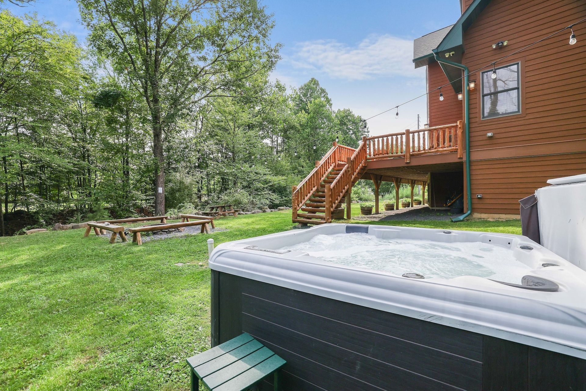 There is a hot tub in the backyard of a house.