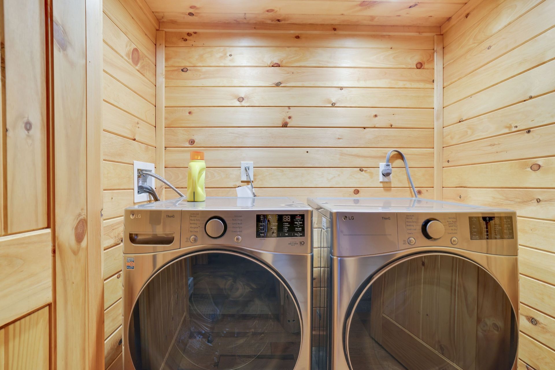 There are two washers and dryers in the laundry room.