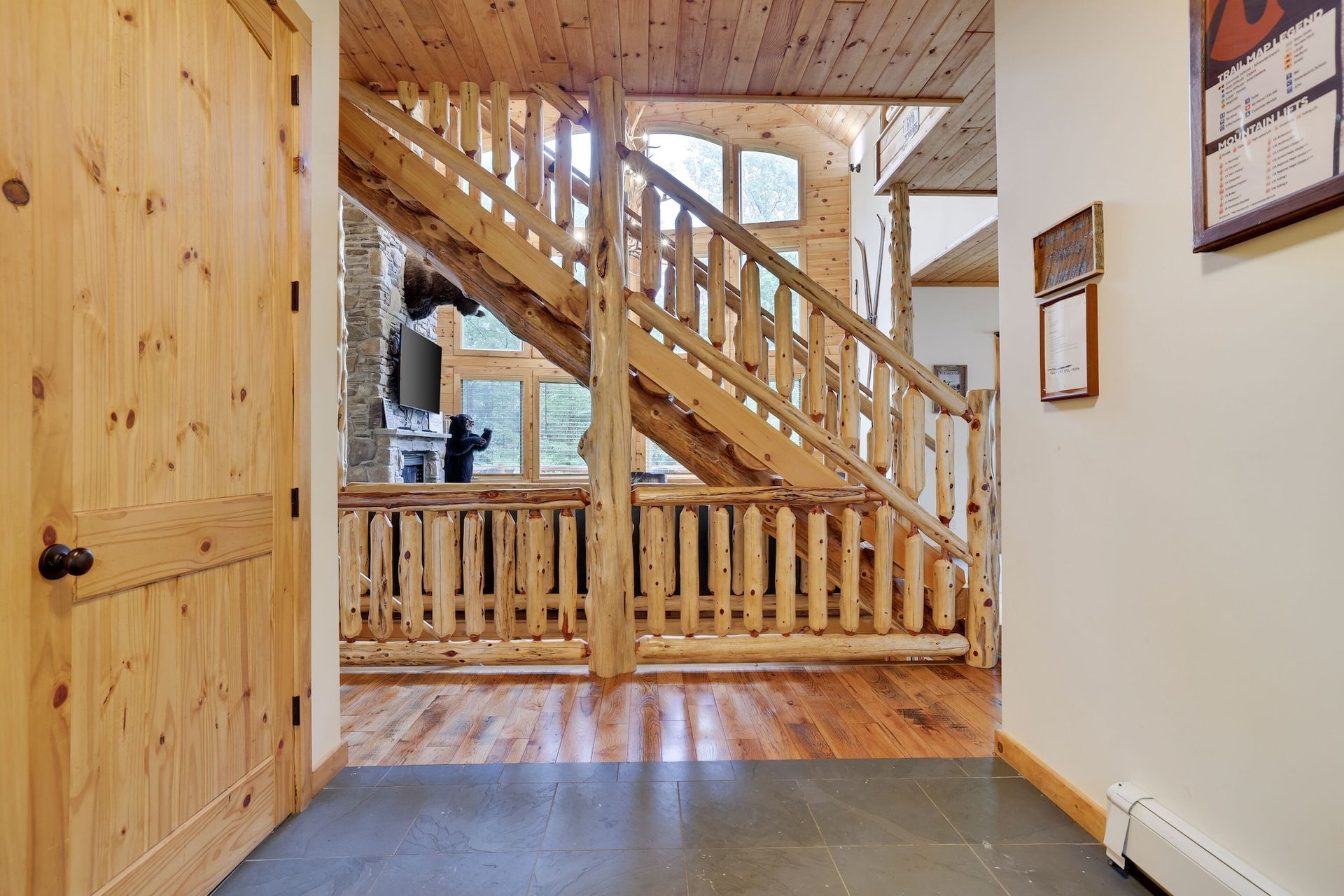 A hallway with a wooden staircase leading up to the second floor of a house.