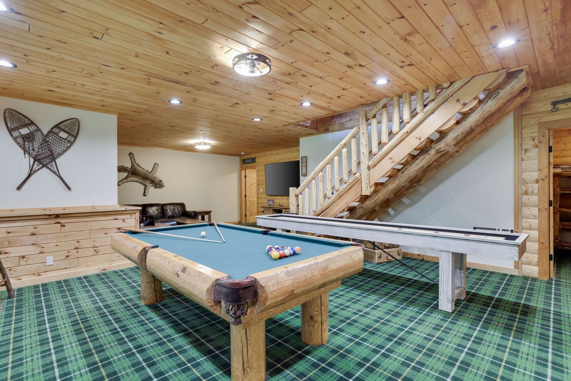 There is a pool table in the middle of the room.