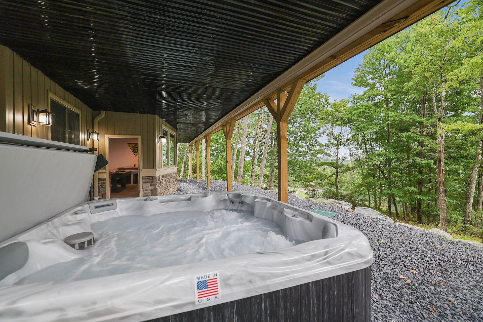 There is a hot tub on the porch of a house.