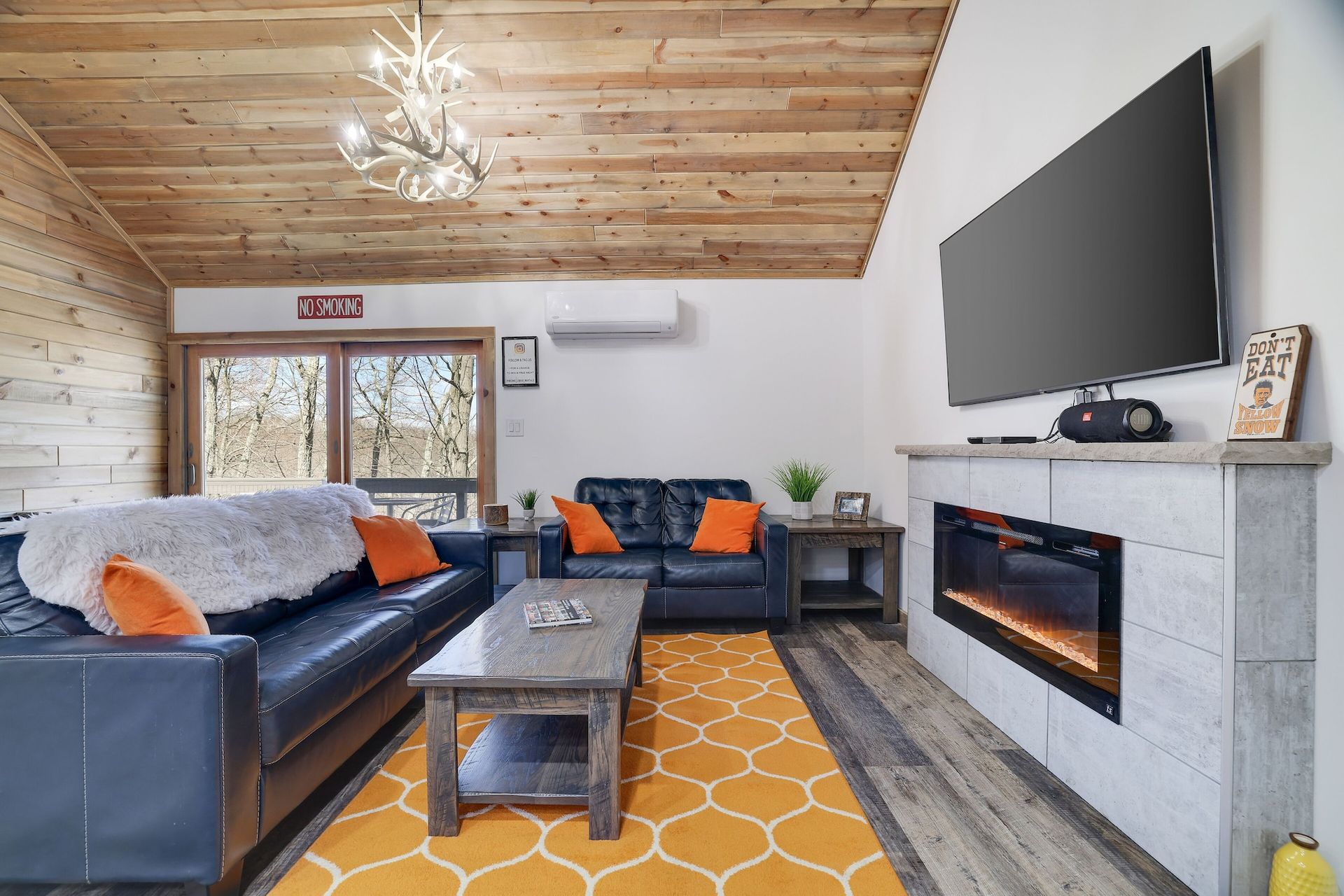 A living room with a fireplace and a flat screen tv