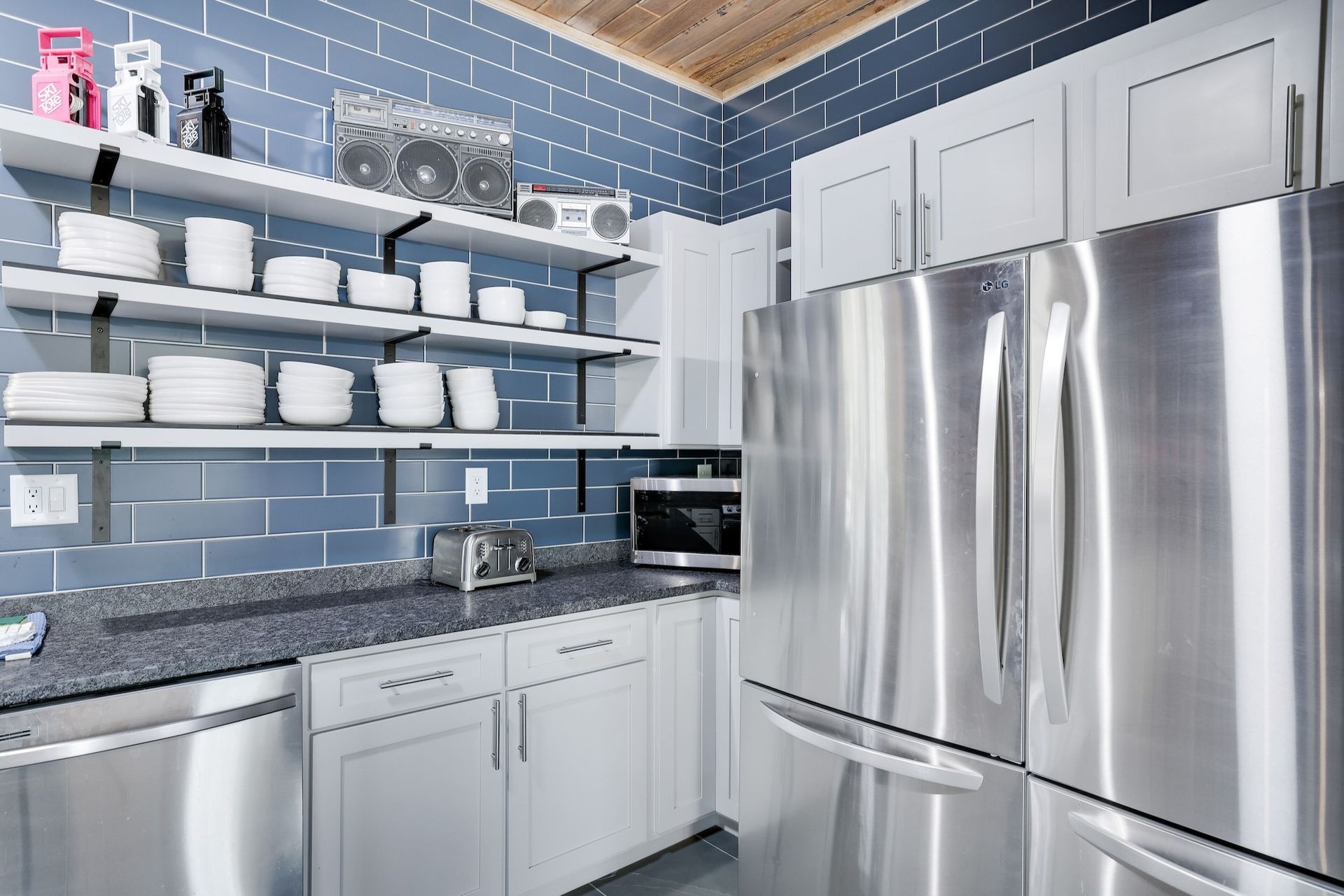 A kitchen with stainless steel appliances and white cabinets