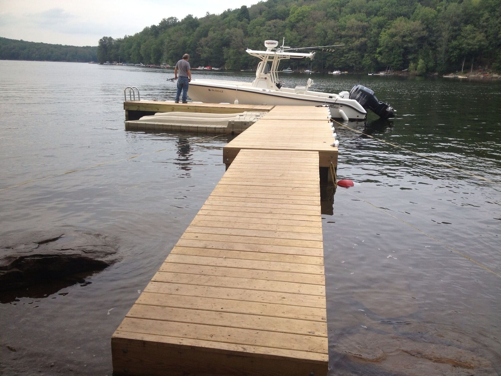 A boat is docked at a dock on a lake