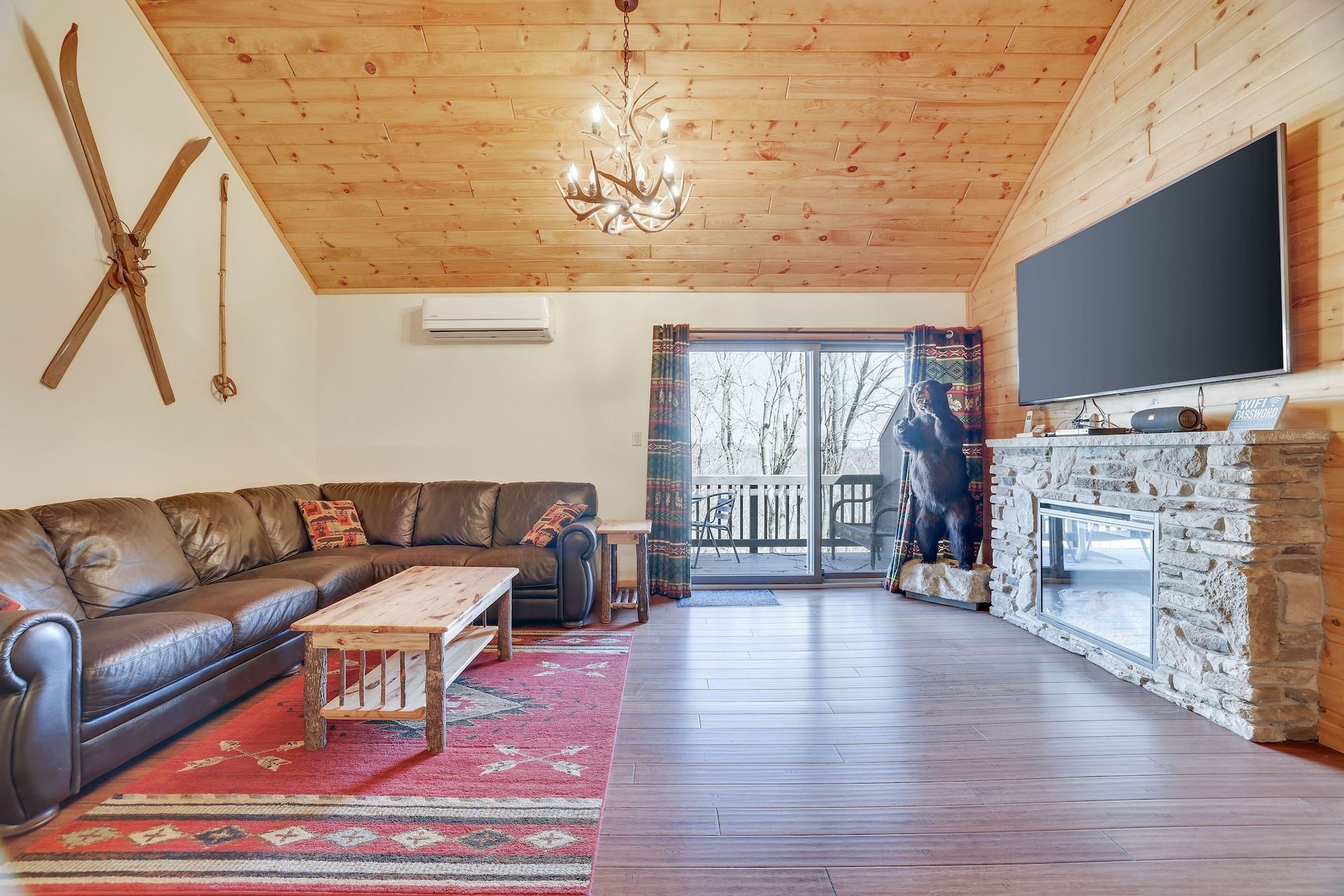 A living room with a fireplace and a flat screen tv.