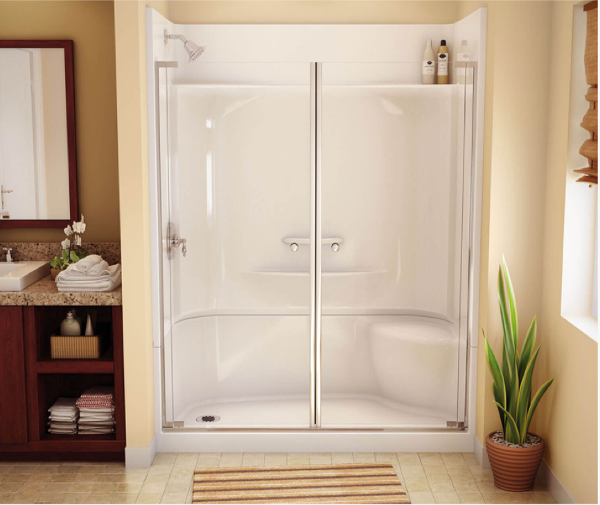 White glass shower enclosure in a beige bathroom with wood shelving and a potted plant