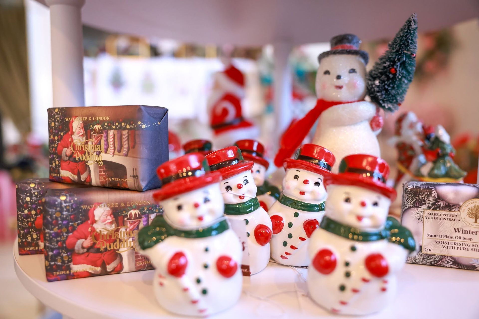 Christmas snowman figurines and festive holiday boxes displayed on a table