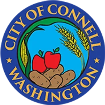 City of Connell, Washington seal with corn, apples, wheat, and potatoes on a blue background