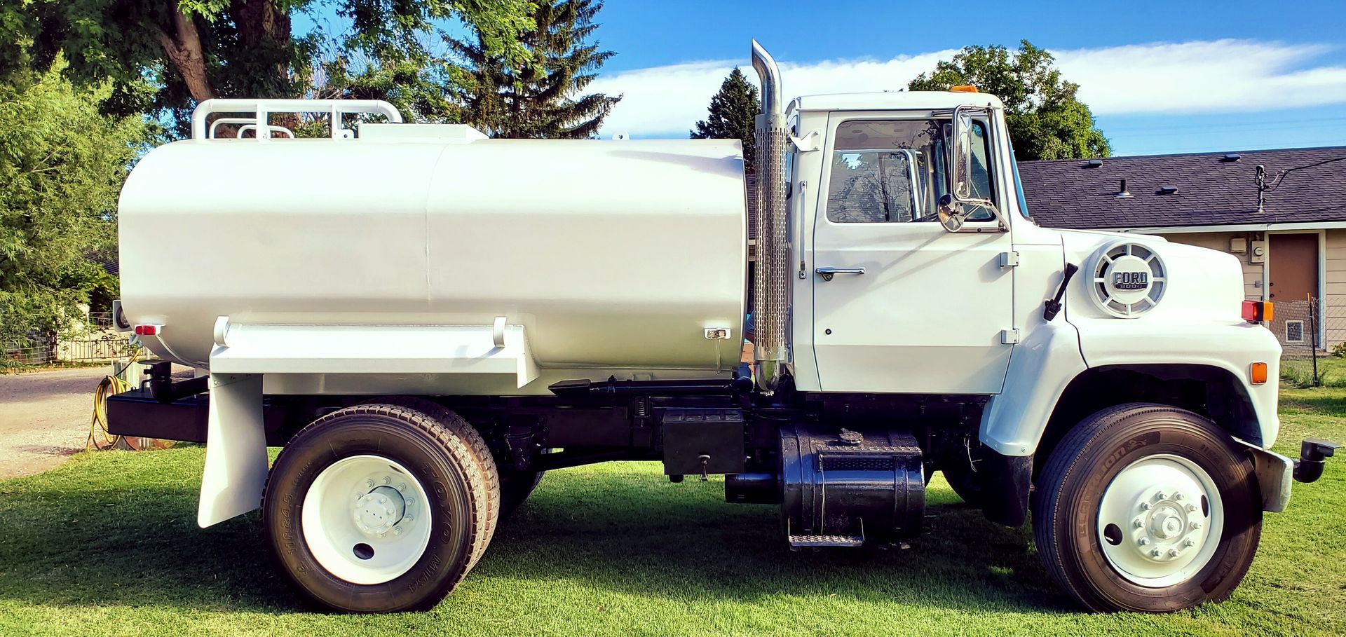 White water tanker truck parked outdoors on a sunny day