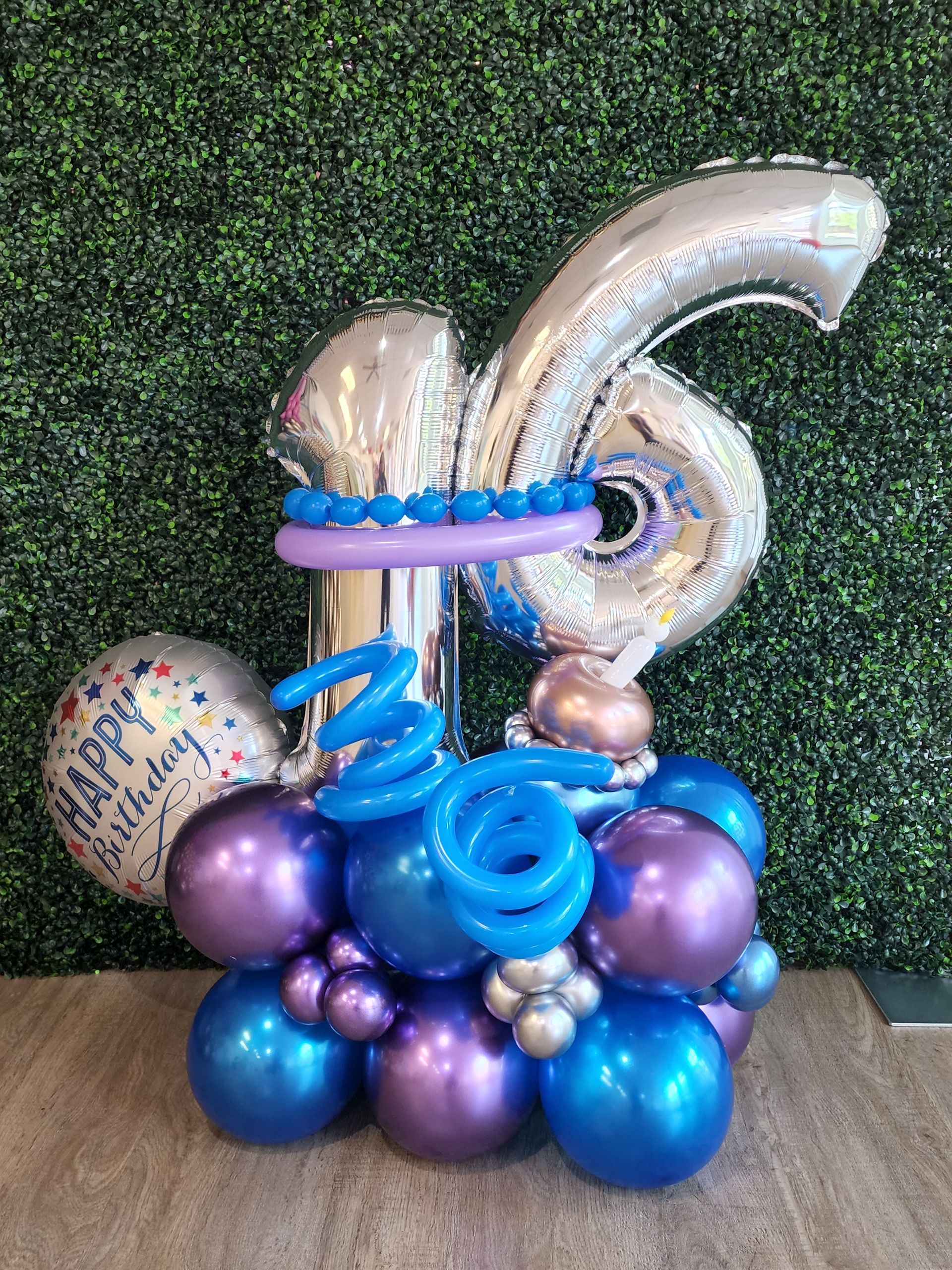 A bunch of balloons are sitting on top of each other on a table.