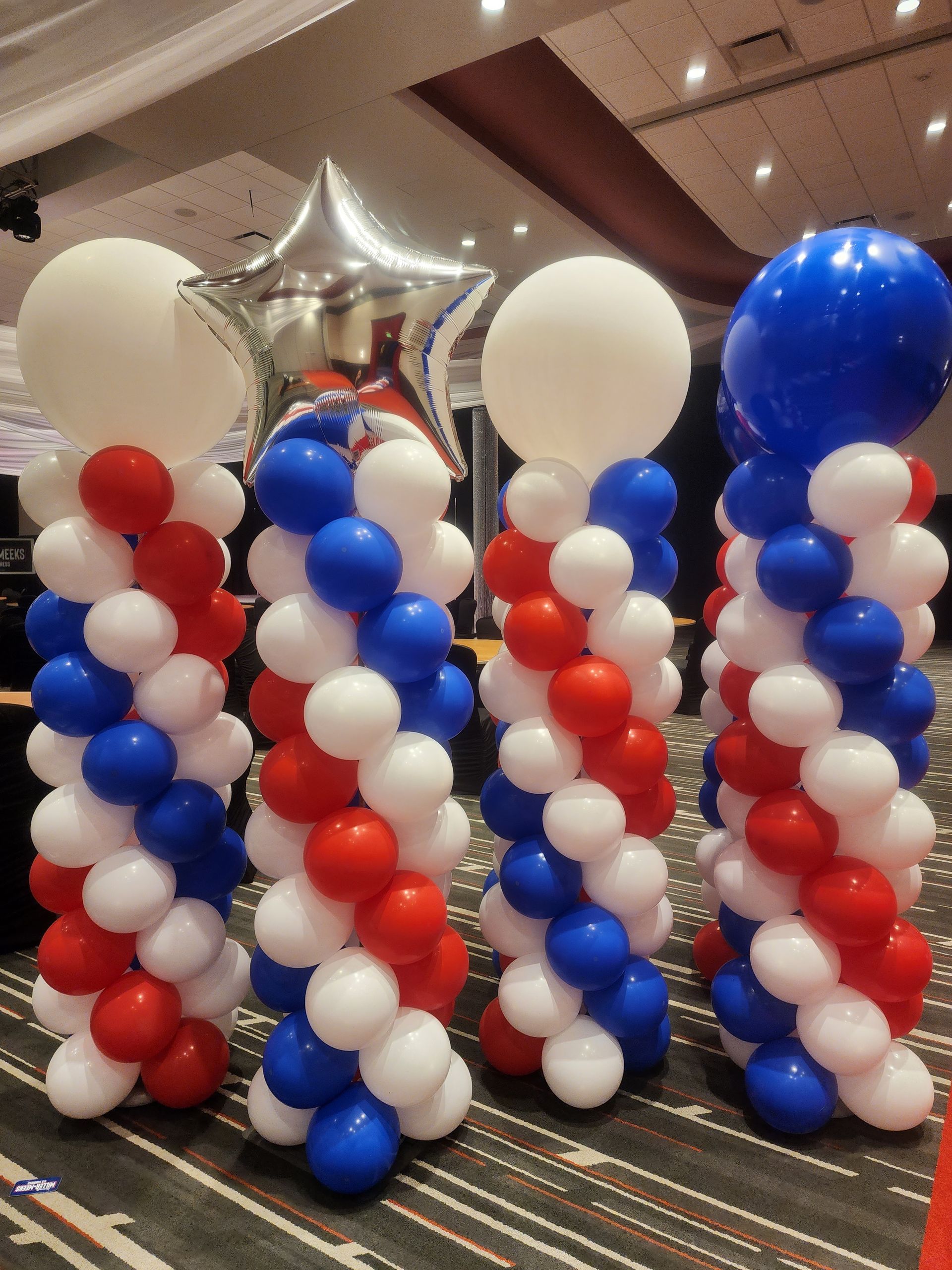 Two red and white heart shaped balloons with the names renee and janet on them