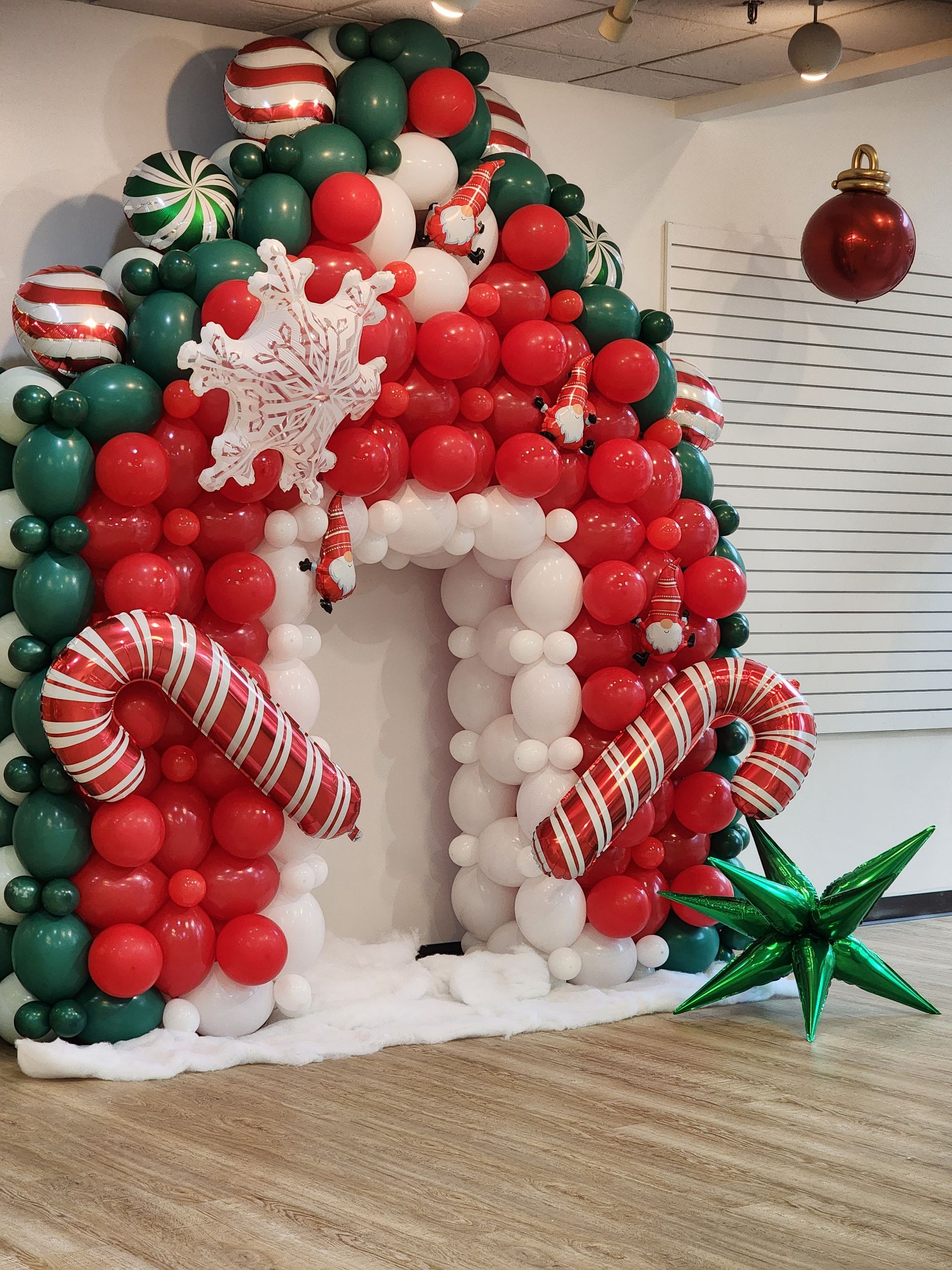 A gingerbread house made out of balloons and candy canes