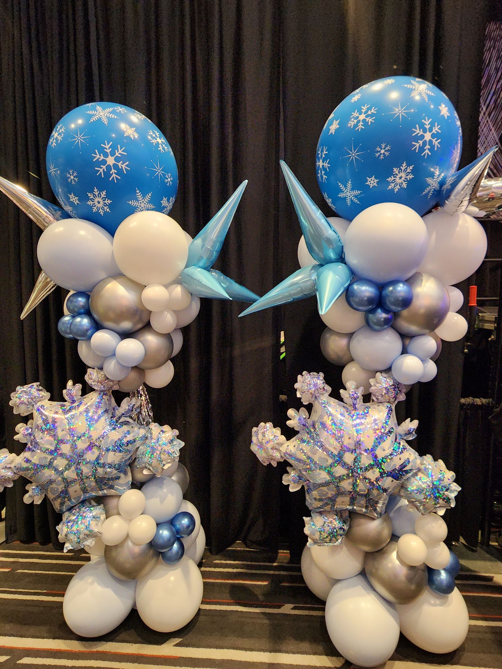 A couple of balloons sitting on top of each other on a table.