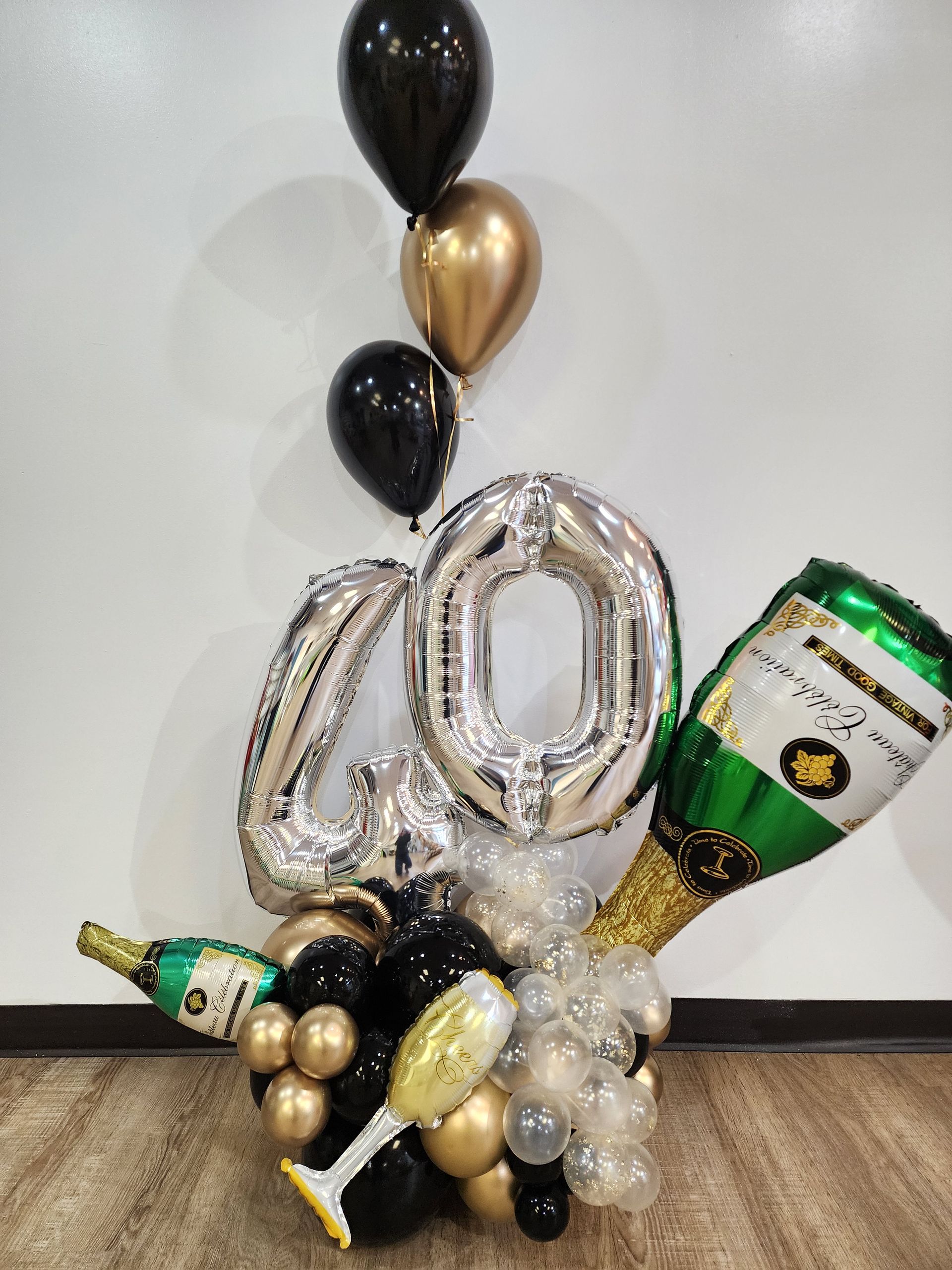 A bunch of balloons and champagne bottles are sitting on a table.