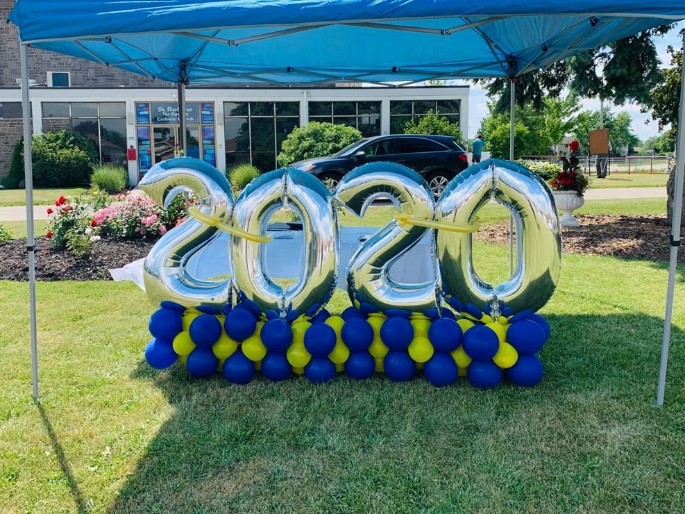 A bunch of balloons with the year 2020 on them