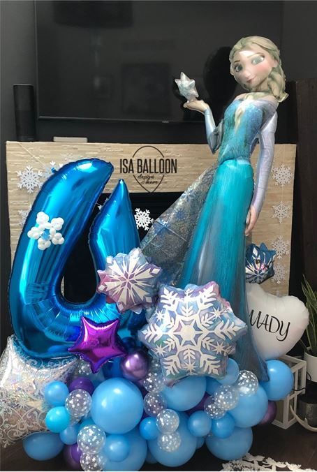 A giant elsa balloon is surrounded by blue balloons.