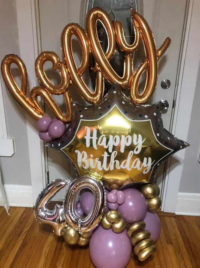 A bunch of balloons are sitting on a wooden floor.