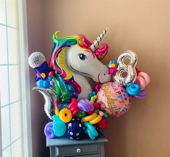 A unicorn shaped balloon with the number 8 on it
