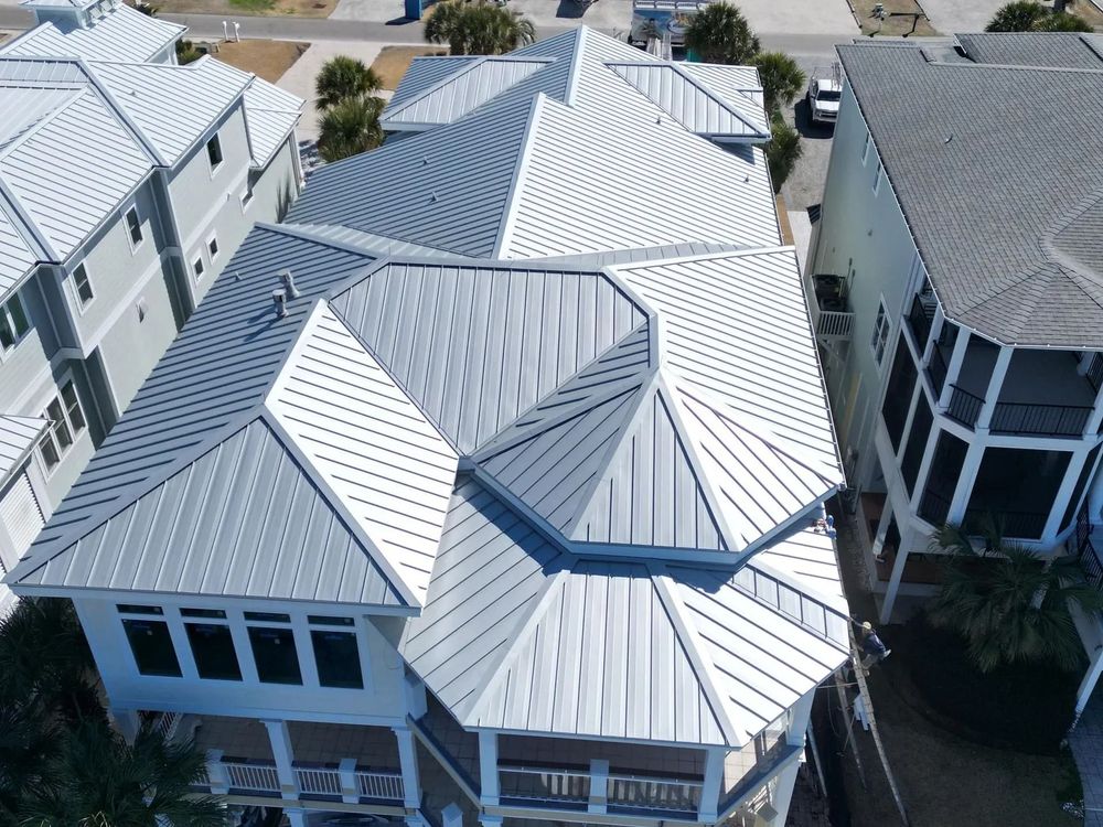 Aerial view of modern homes with silver metal roofs in a suburban neighborhood