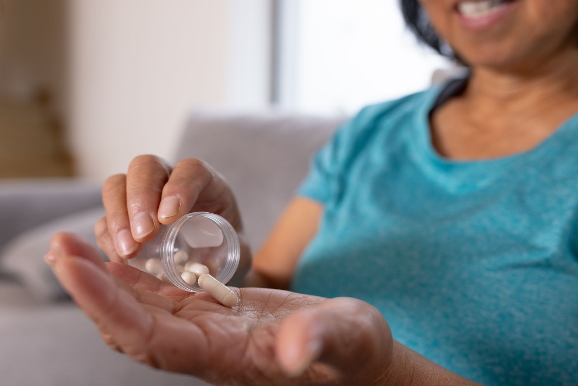 A woman is taking some pills. A woman is taking some pills.