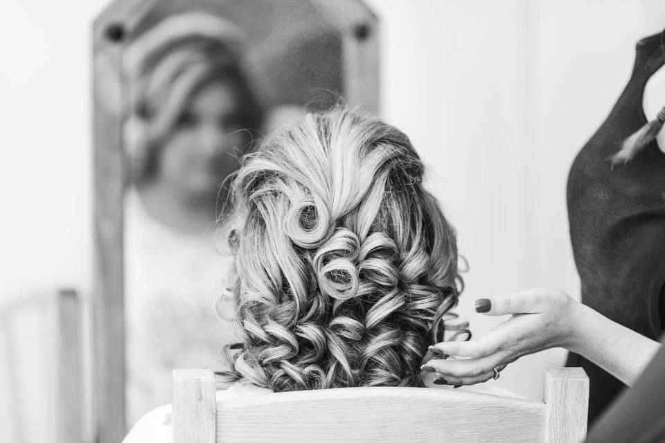 Woman with hair styled in an up-do for wedding day