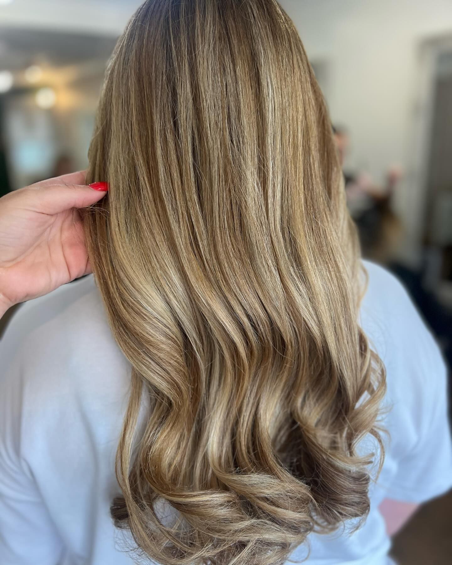 Woman with blond hair, cut and styled. She also has her make up done.