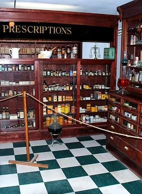 Vintage pharmacy interior with wooden prescription shelves, glass bottles, and black-and-white tile floor