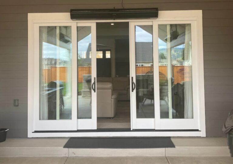 Open white sliding glass doors leading into a modern home entryway