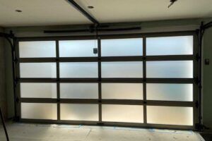 Modern frosted glass garage door with dark grid frame in a room interior