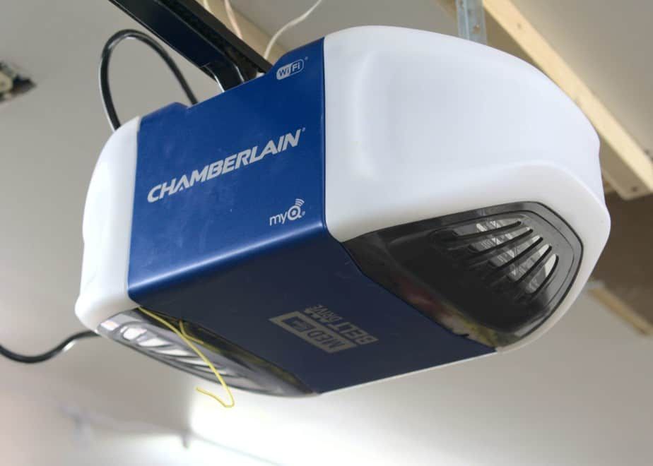Chamberlain garage door opener mounted on the ceiling, blue and white корпус with a light lens