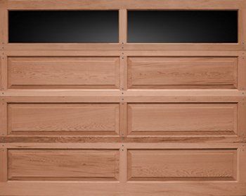 Wooden garage door with four raised panels and two dark window panes at the top