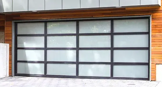 Large frosted glass garage door with dark metal framing set in a wooden exterior