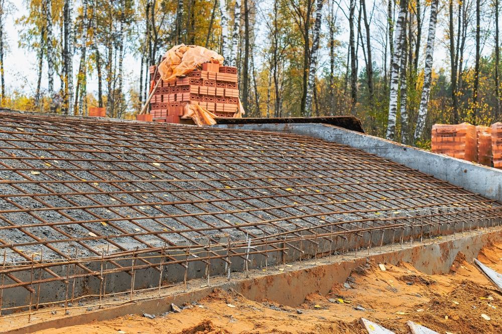 A Pile of Bricks is Sitting on Top of a Concrete Slab — Downright Carpentry in Miles End, QLD