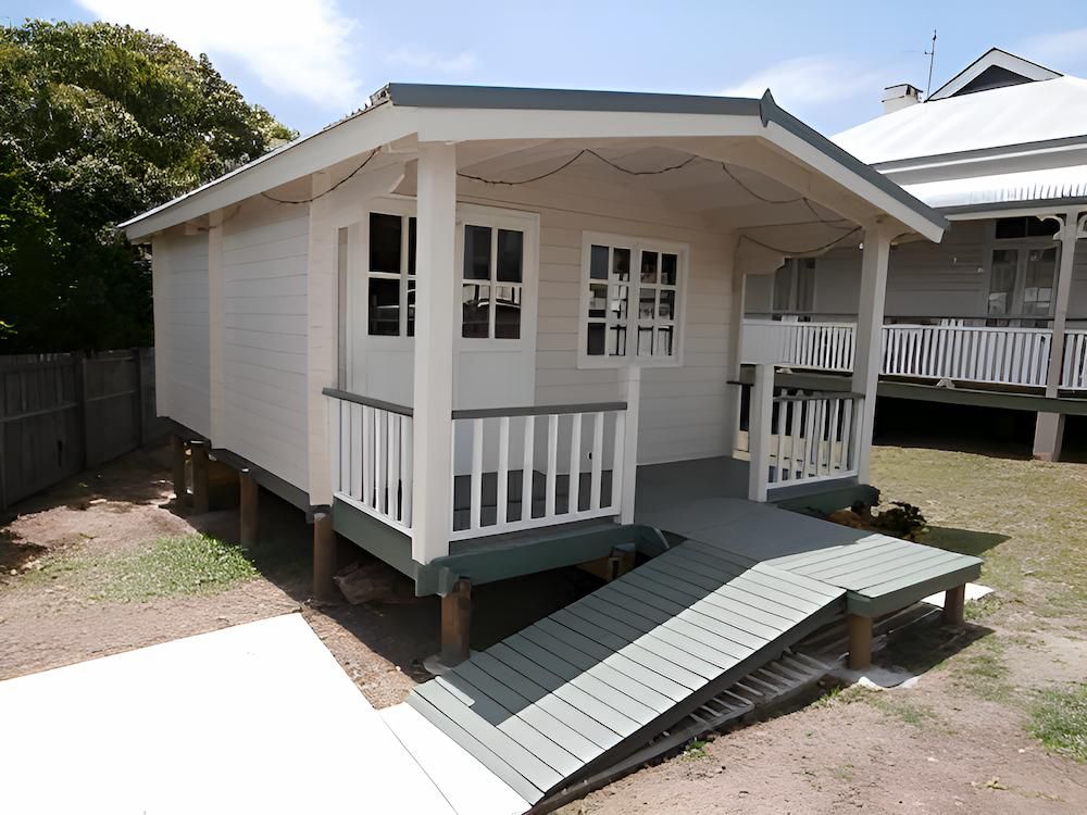 A Small White House With a Ramp in Front of It — Downright Carpentry in Ryan, QLD