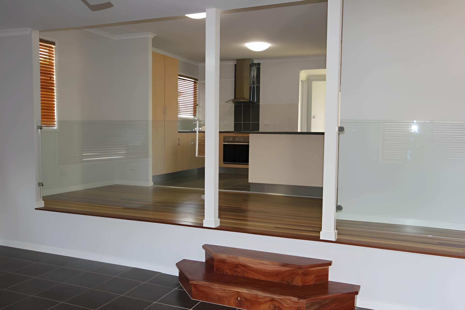 An Empty Room With Stairs Leading Up to a Kitchen — Downright Carpentry in Miles End, QLD