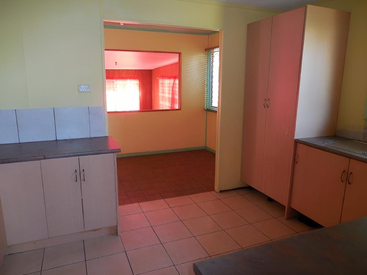 New Renovation Empty Kitchen With Pink Cabinets — Downright Carpentry in Ryan, QLD