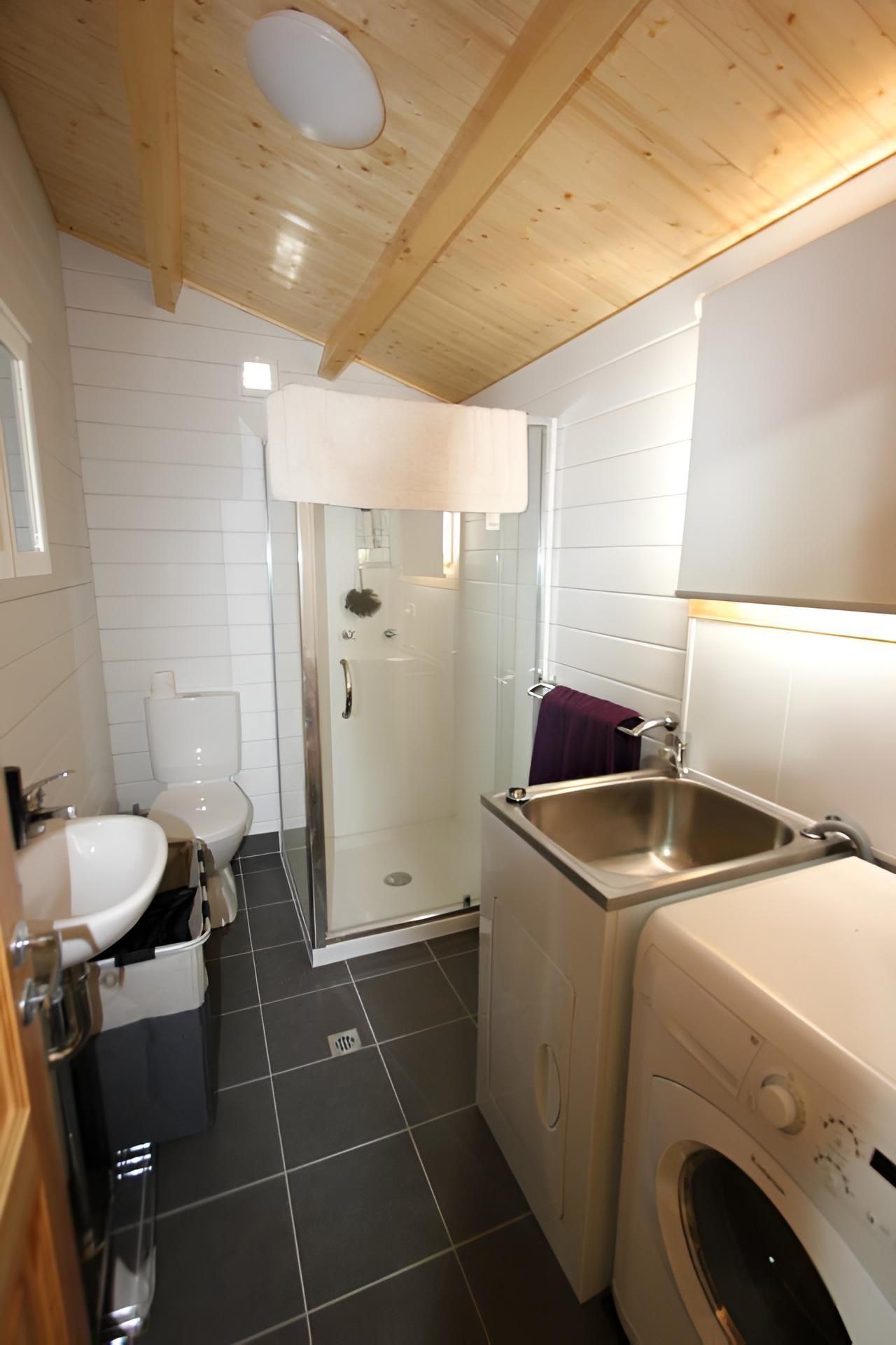 A Bathroom With a Sink, Washer and Dryer — Downright Carpentry in Mornington, QLD