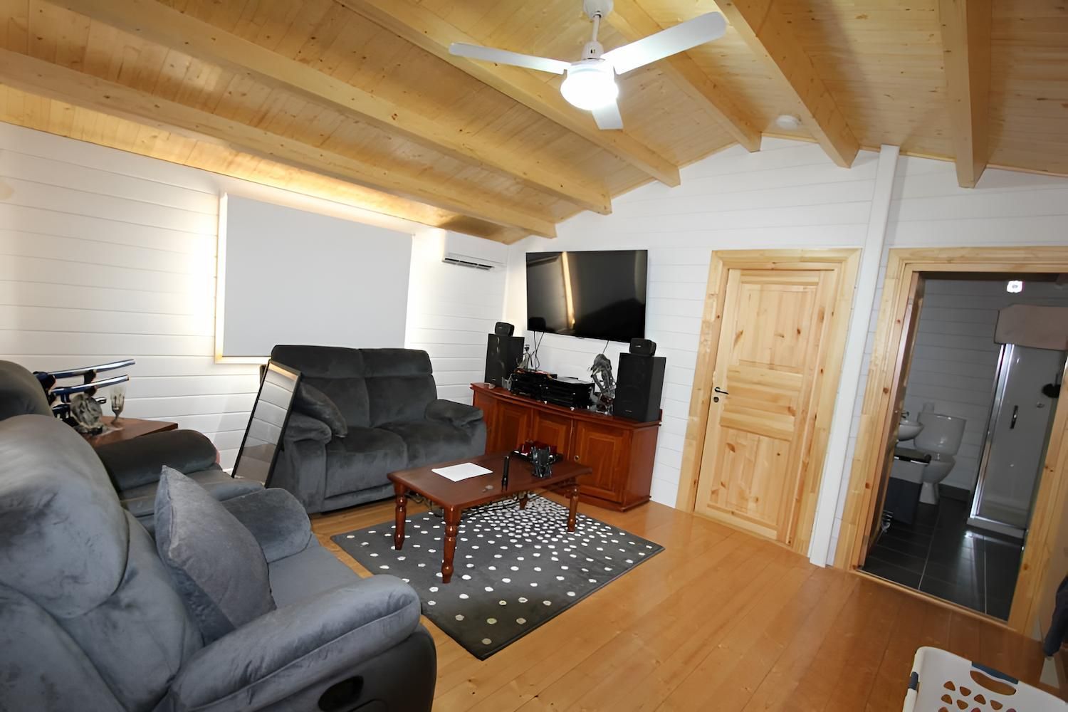 A Living Room With a Ceiling Fan and a Couch — Downright Carpentry in Mornington, QLD