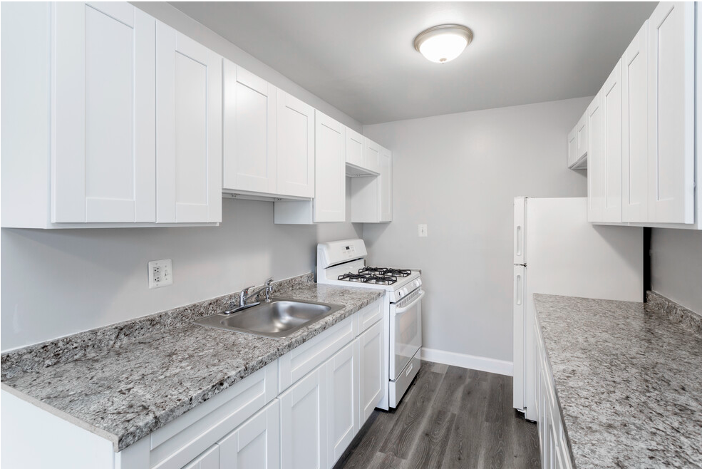 Upgraded kitchen with granite countertops and grey flooring