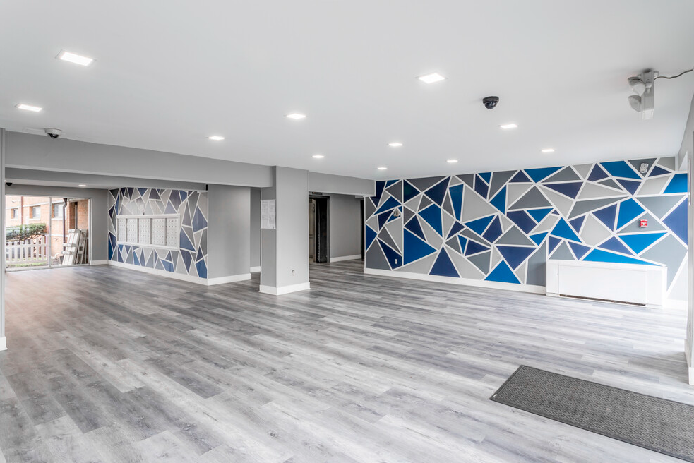 The Swift and Current Apartments lobby with grey flooring and blue and grey patterned wall paper