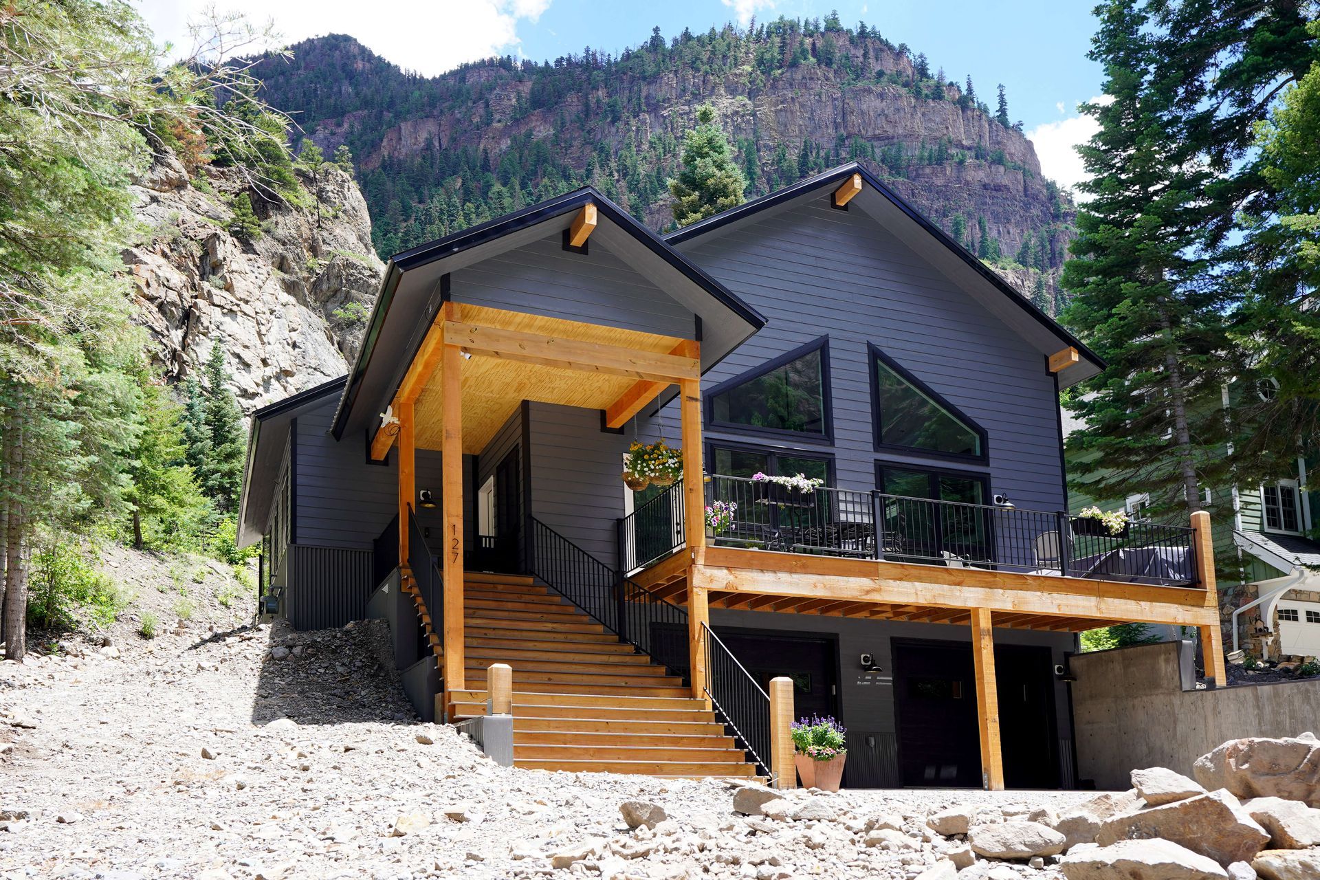 A house with a large deck and stairs leading up to it