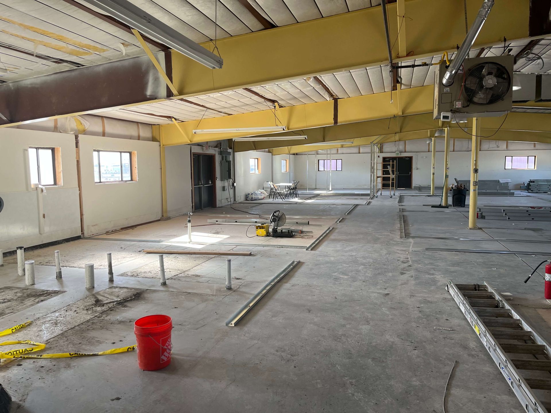 An empty building with a red bucket in the middle Maven Construction, Montrose, CO